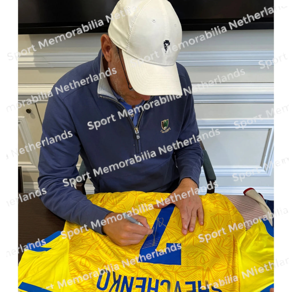 Signing proof of Andriy Shevchenko signing an official Ukraine 2026-27 football shirt during a private signing session.