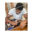 Signing proof of Anthony Joshua signing a boxing photo during a private signing session.