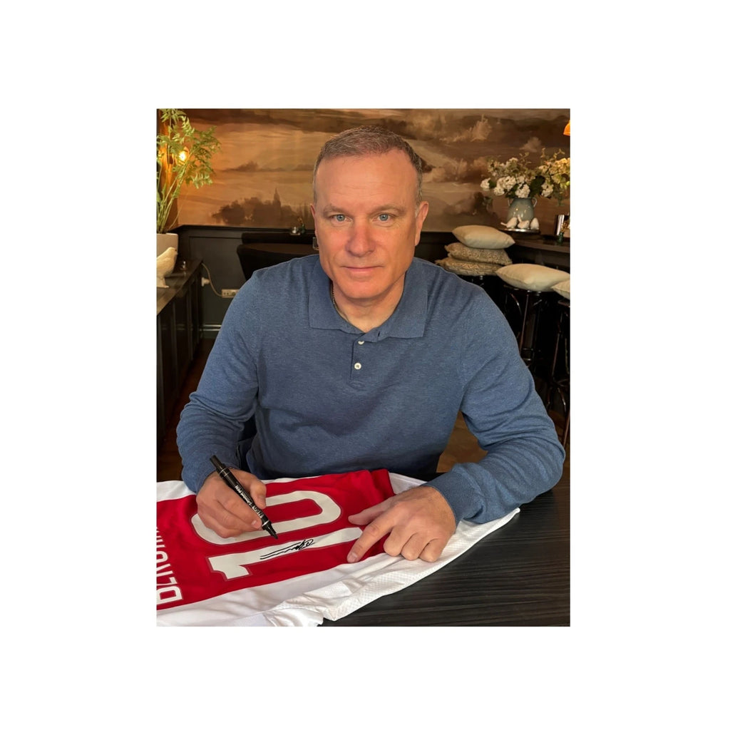 Dennis Bergkamp posing with his signed Ajax 2024-2025 home football shirt after the private signing session for Sport Memorabilia Netherlands.