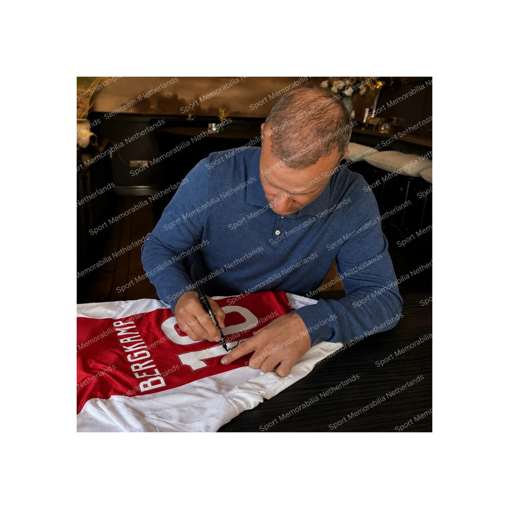 Dennis Bergkamp signing an Ajax 2024-2025 home football shirt during a private signing session for Sport Memorabilia Netherlands.