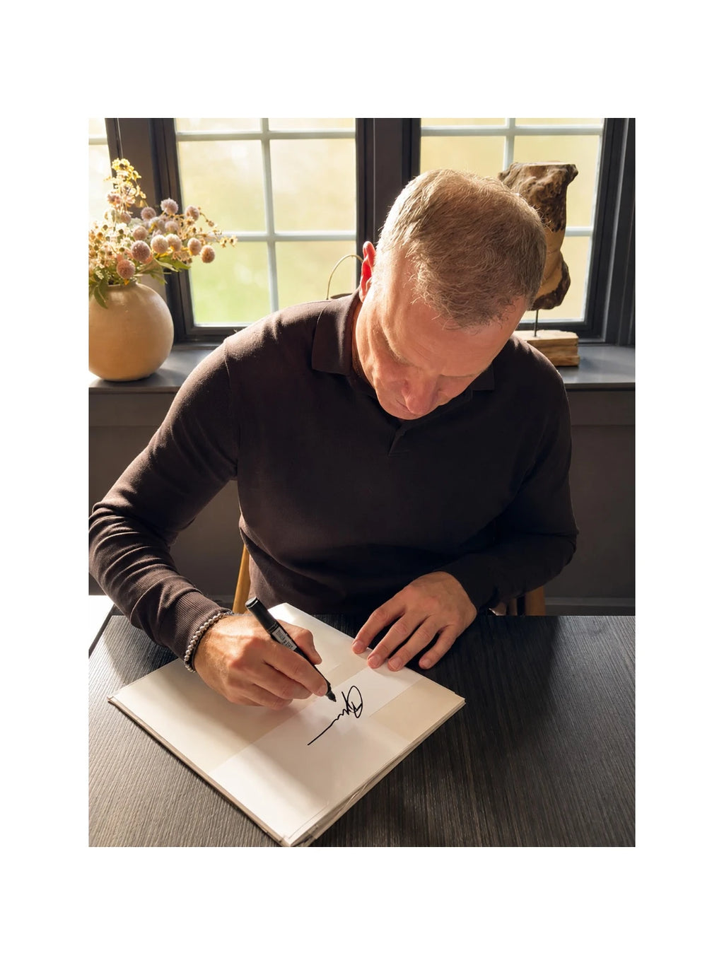 Signing proof of Dennis Bergkamp signing an official Inter Milan football shirt during a private signing session.
