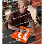 Signing proof of Didier Drogba signing an official Ivory Coast 2003 football shirt during a private signing session.