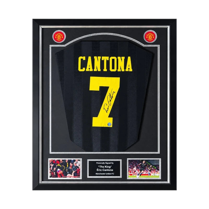 Vooraanzicht van een zwart Manchester United 1994-1996 uitshirt, gesigneerd door Eric Cantona op geel rugnummer 7, ingelijst in een zwart-zilveren Deluxe Frame met twee actiefoto's.