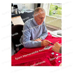 Signing proof of Geoff Hurst signing an official England football shirt during a private signing session.