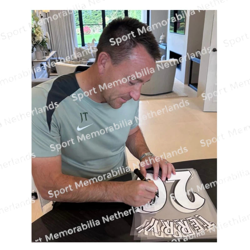 Signing proof of John Terry signing a Chelsea football shirt during a private signing session.