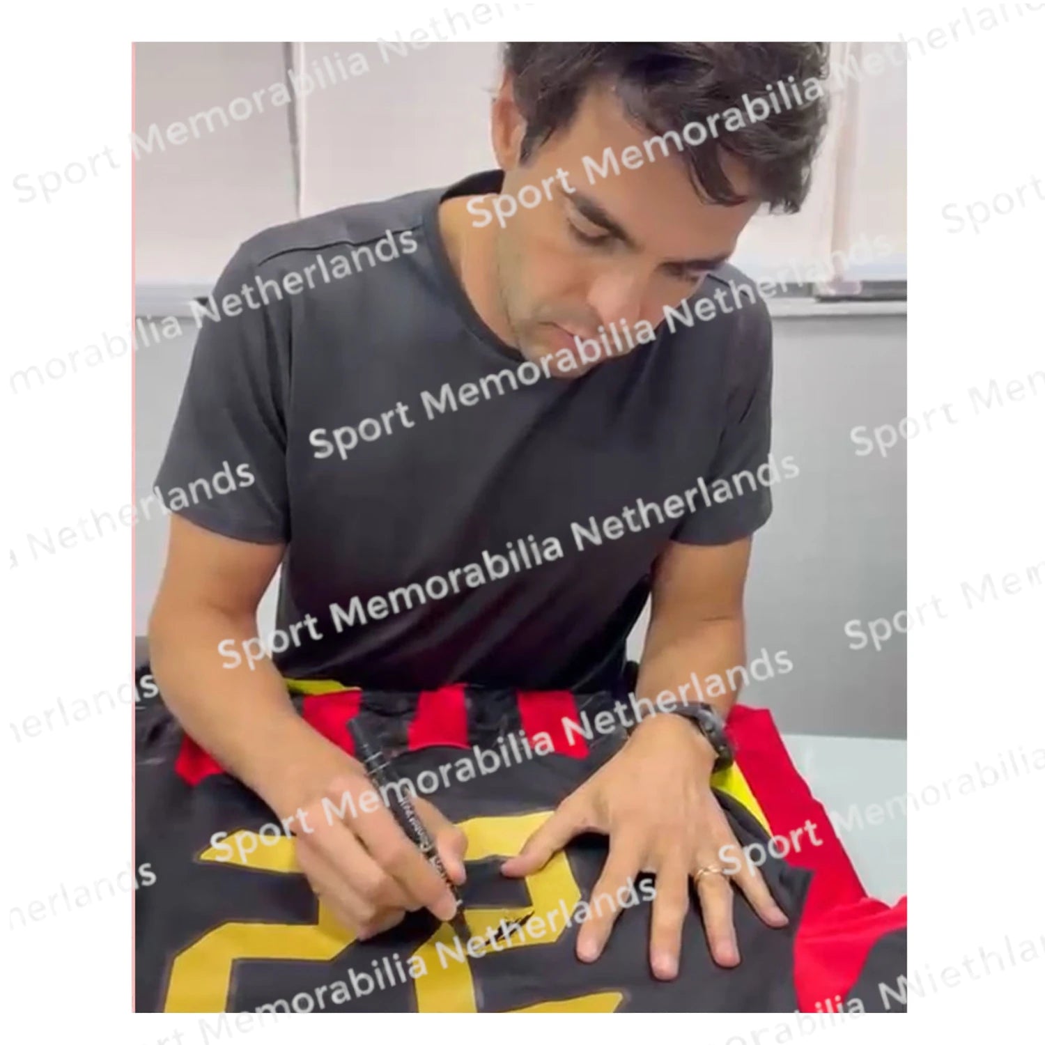 Signing proof of Kaká signing an official AC Milan football shirt during a private signing session.