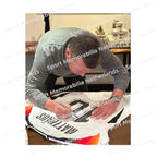 Signing proof of Lothar Matthäus signing an official Germany 2024 football shirt during a private signing session.