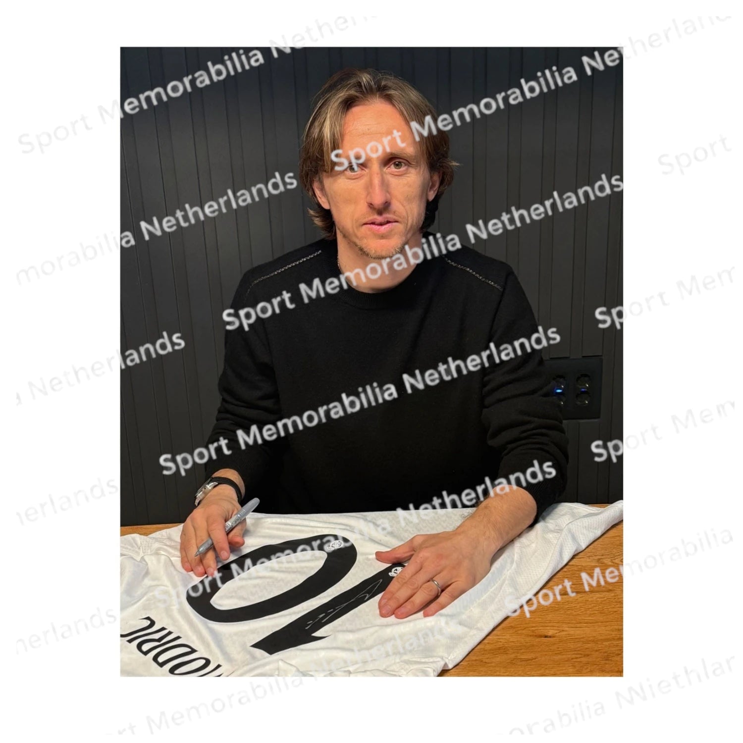 Signing proof of Luka Modrić signing an official Real Madrid 2024 football shirt during a private signing session.