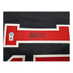 Detail van de handtekening van Magic Johnson op het basketbalshirt met authenticiteitssticker