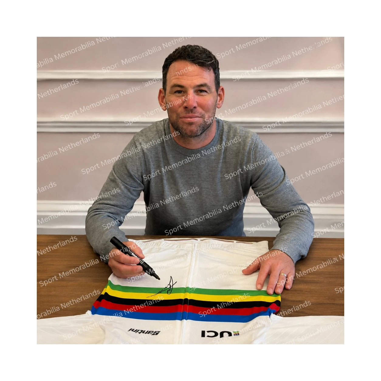 Signing proof of Mark Cavendish signing an official UCI World Champion rainbow jersey during a private signing session.