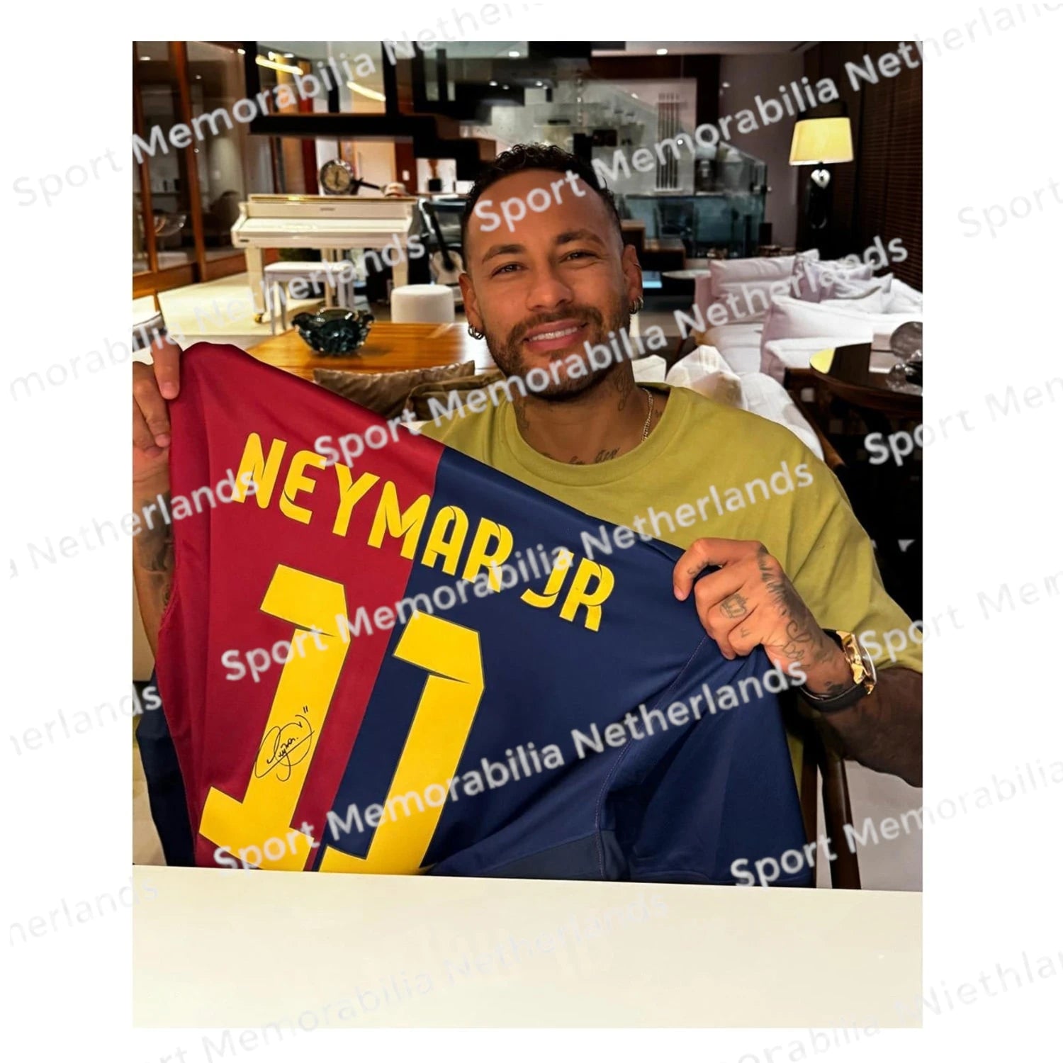 Signing proof of Neymar da Silva Santos Júnior with a signed Barcelona football shirt.