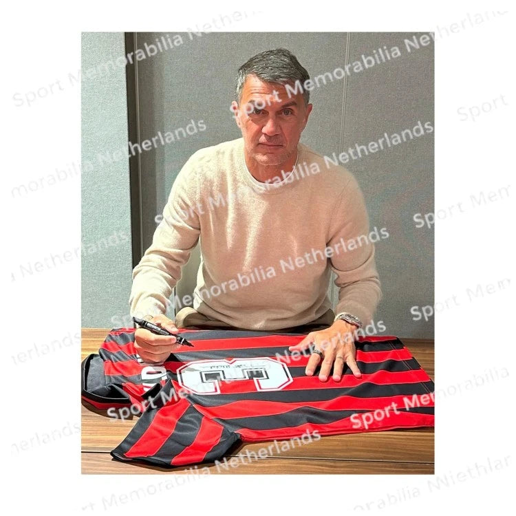 Signing proof of Paolo Maldini signing an official AC Milan 1988 football shirt during a private signing session.