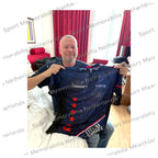 Raymond van Barneveld holding his signed Target RVB darts shirt during the signing session in England.