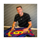 Robert Lewandowski signing a Barcelona football shirt number 9 during a private signing session.