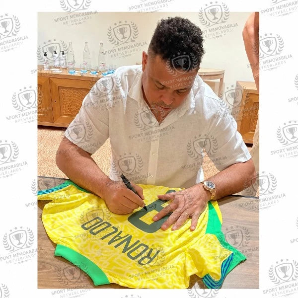 Ronaldo Luís Nazário de Lima signing an official Brazil 2024 home football shirt during a private signing session.