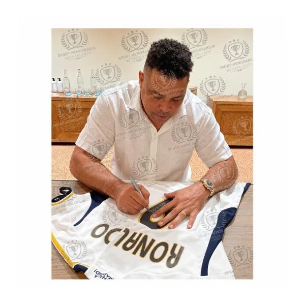 Ronaldo Luís Nazário signing a Real Madrid 2023-24 home football shirt during a private signing session 