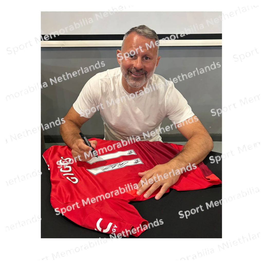 Signing proof of Ryan Giggs signing an official Manchester United football shirt during a private signing session.