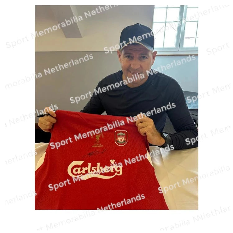 Signing proof of Steven Gerrard signing an official Liverpool 2005 Champions League football shirt.