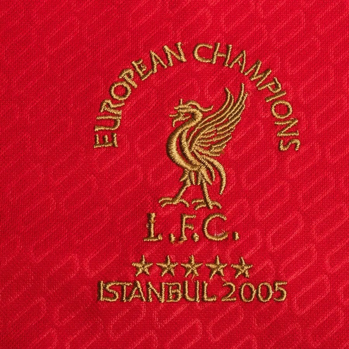 Detail van het rode Liverpool 2005 voetbalshirt met gouden European Champions Istanbul 2005-borduursel.