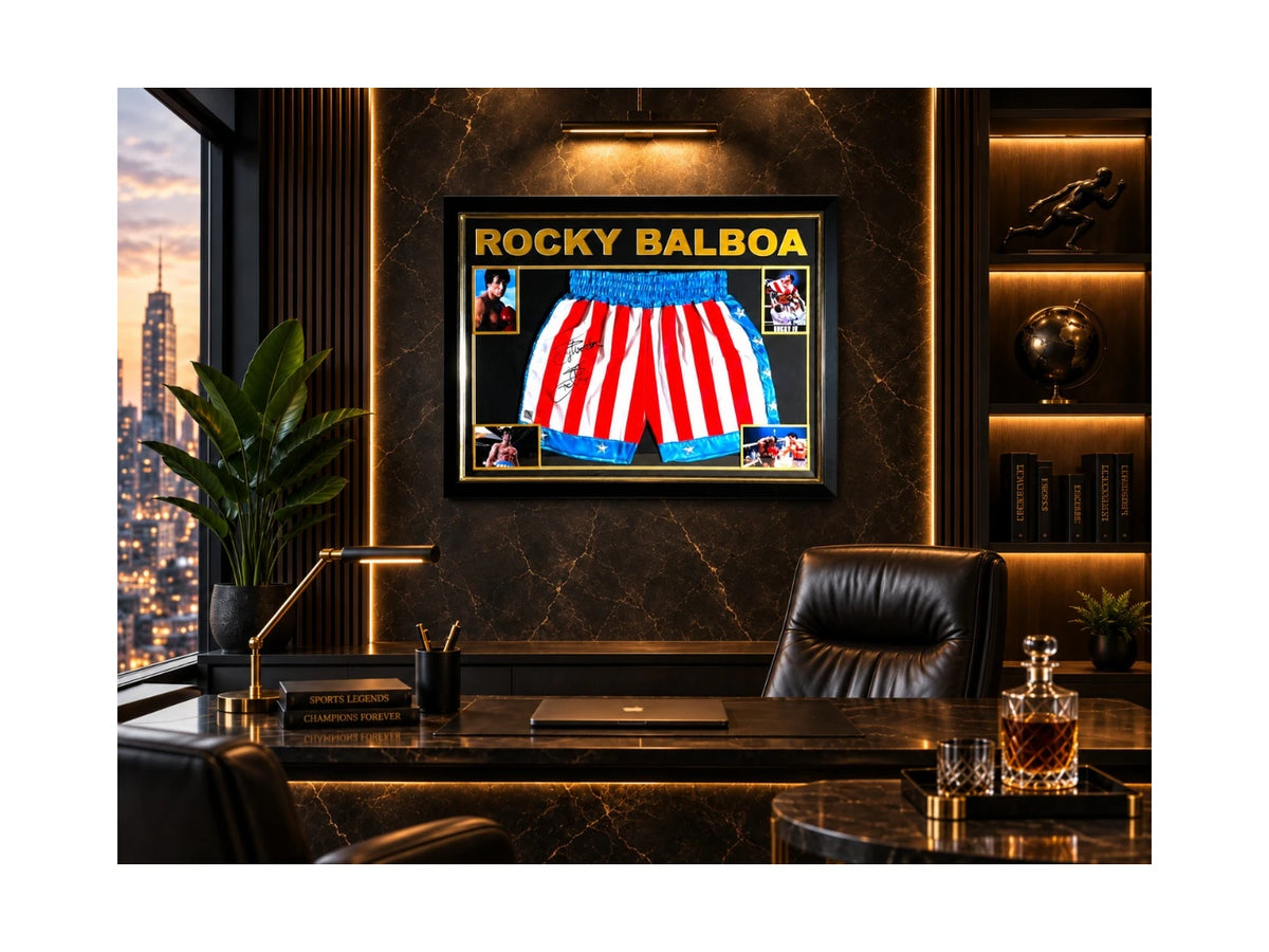 Ingelijste Rocky Balboa-boksbroek gesigneerd door Sylvester Stallone, gepresenteerd in een luxe kantoorinterieur.