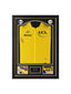 Framed Tour de France 2025 yellow jersey signed by Tadej Pogačar, professionally displayed with two cycling action photos.