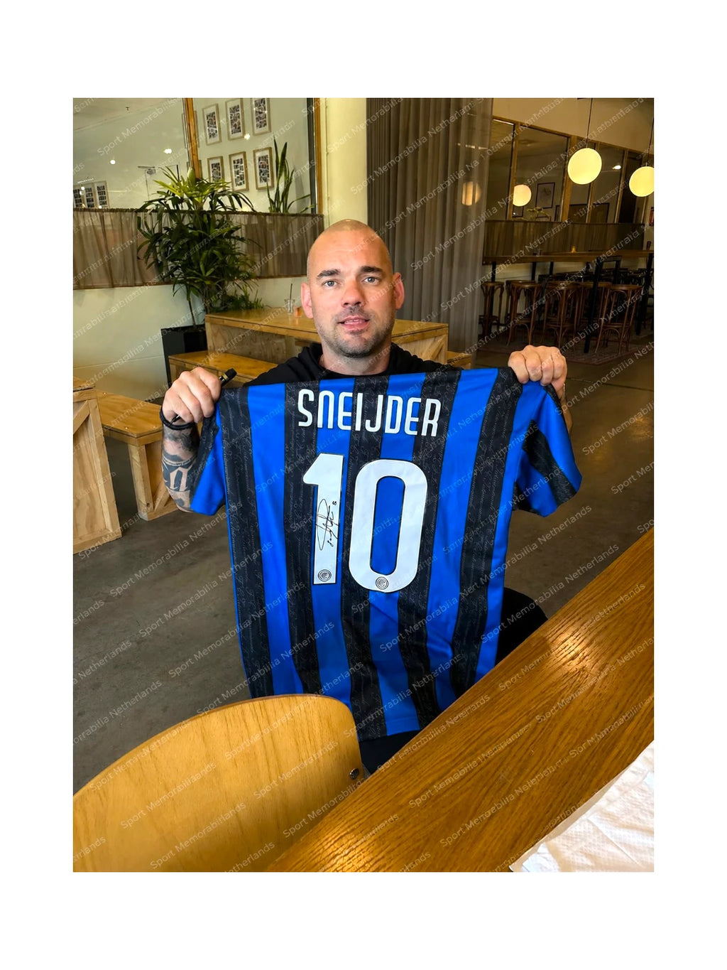 Wesley Sneijder holding a signed Inter Milan football shirt number 10 during a private signing session.