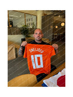 Wesley Sneijder holding a signed Netherlands football shirt number 10 during a private signing session.