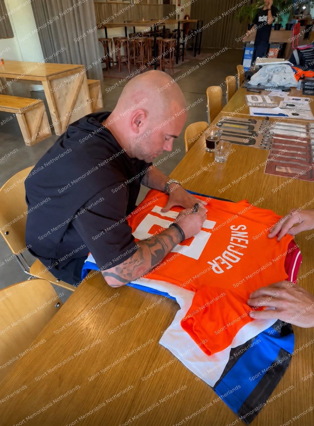 Wesley Sneijder signing a Netherlands football shirt number 10 during a private signing session.