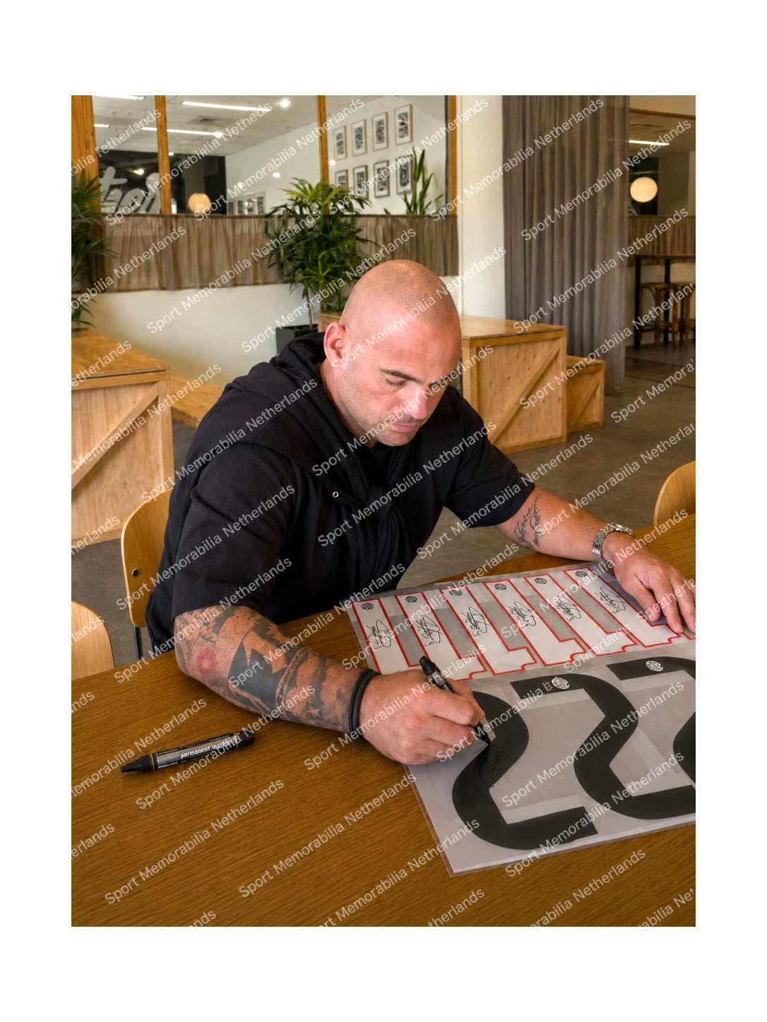 Wesley Sneijder signing a Real Madrid football shirt number 23 during a private signing session.
