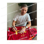 Signing proof of Xabi Alonso signing an official Spain football shirt during a private signing session.
